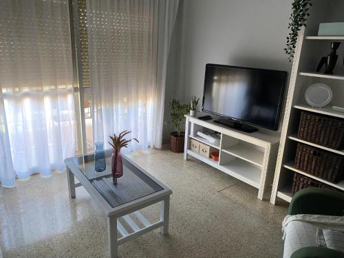 a living room with a tv and a coffee table at Bahia de Algeciras in Algeciras