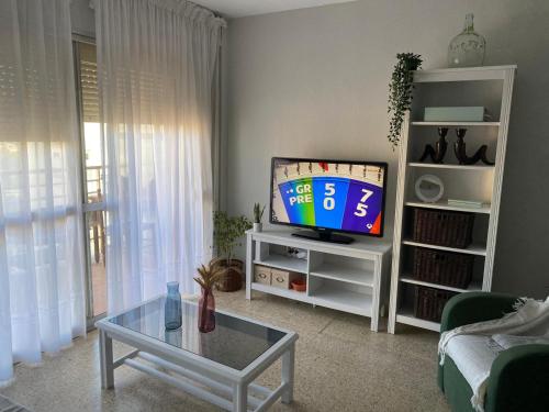 a living room with a tv and a table at Bahia de Algeciras in Algeciras