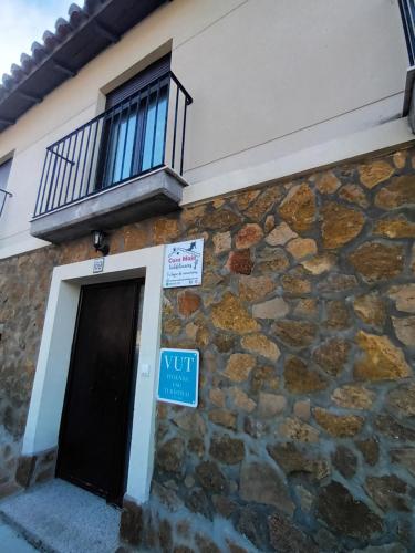 un edificio de piedra con una ventana y una puerta en Casa Majo Valdelinares VUTE-23-002 en Valdelinares