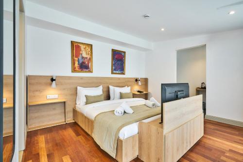 a bedroom with a large bed and a television at Joyway Hotels Istanbul Sultanahmet in Istanbul