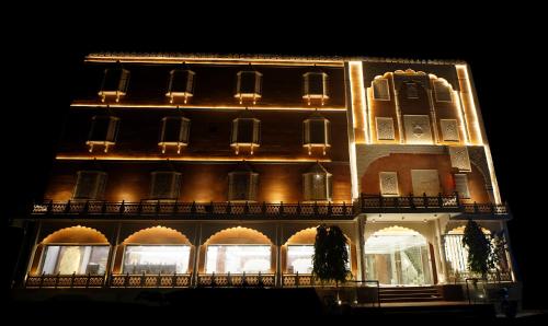 a lit up building at night with lights at HOTEL PRAHLAD INN in Gwalior