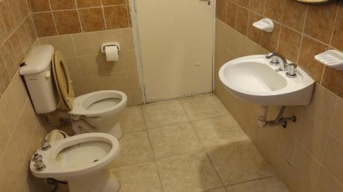a bathroom with a toilet and a sink at Orense in La Rioja