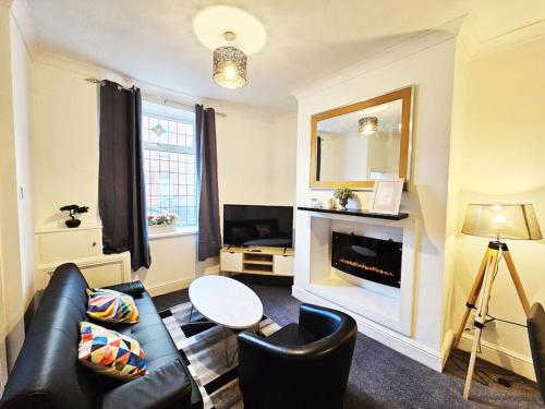 a living room with a couch and a table at Failsworth, Manchester in Manchester