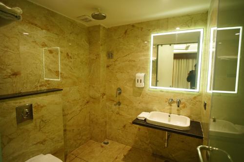 a bathroom with a sink and a mirror at HOTEL PRAHLAD INN in Gwalior