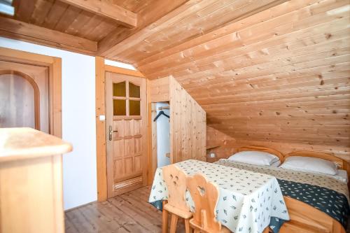 a bedroom with a bed in a wooden room at Willa Pod Orłem Jacuzzi Sauna in Kościelisko