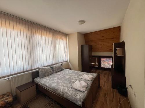 a small bedroom with a bed and a window at Panorama Guest House in Smolyan