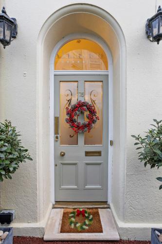 a white door with a wreath on it at Kingston House in Torquay