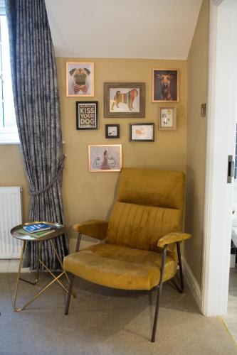 a living room with a chair and a table at The Dog in Over Peover in Knutsford