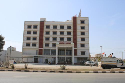 a large building with a truck parked in front of it at Clarks Collection Somnath in Somnath