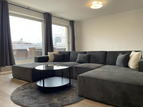 a living room with a couch and a table at NP Hotel Königshof in Dortmund