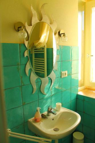 a bathroom with a sink and a mirror on the wall at LA CUCCAGNA DI DON BOSCO - No landlords and neighbours - Absolute privacy! in Montafia