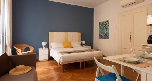 a room with a bed and a table with a dining room at Russomanno Apartments in Como