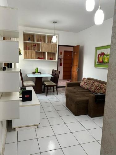 a living room with a couch and a table at APARTAMENTO CONFORTO in São Luís