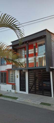 a house with a palm tree in front of it at Donde Memo in Santa Rosa de Cabal