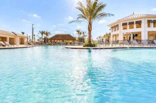 a large swimming pool in front of a building at Magic Marvel Getaway in Kissimmee