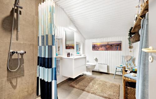 a bathroom with a shower and a sink at Nice Home In Blvand With 3 Bedrooms And Wifi in Blåvand