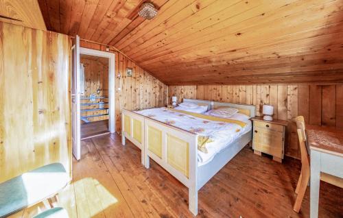 a bedroom with a bed in a wooden cabin at 4 Bedroom Beautiful Home In Lienz in Lienz