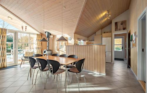 a kitchen and dining room with a table and chairs at Amazing Home In Oksbøl With Wifi in Oksbøl