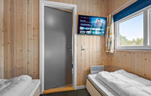 a room with two beds and a window and a door at Amazing Home In Oksbøl With Wifi in Oksbøl