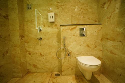 a bathroom with a toilet and a shower at HOTEL PRAHLAD INN in Gwalior