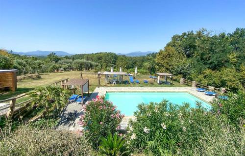a swimming pool in a yard with chairs and trees at Alloro 1 in Montecarlo