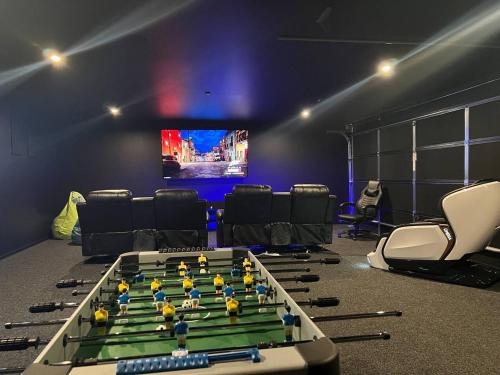 a room with a foos ball table and chairs at New Luxury Home with Games Room and Park Outlook Sleeps 12, 26 mins from CHC airport in Lincoln