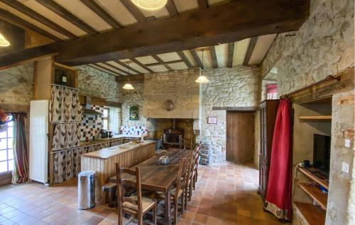 une grande cuisine avec une table et des chaises en bois dans l'établissement Lovely Home In Chiché, à Chiché