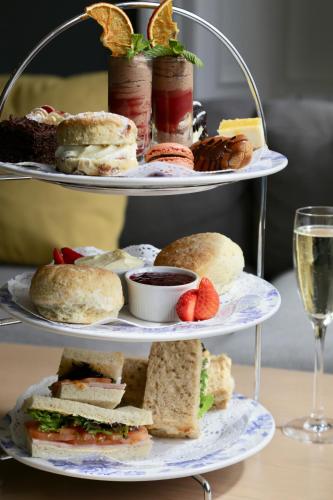 two tiered plates with sandwiches and fruit on them at Old Waverley Hotel in Edinburgh