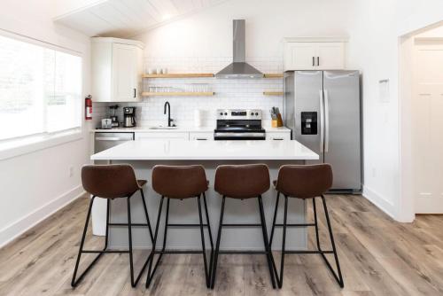 a kitchen with a white counter and a refrigerator at Ocean Lofts in the Vibe #3 - 5 min walk to beach in Virginia Beach