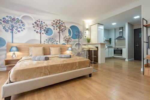 a bedroom with a large bed and a kitchen at Budapest Holidays Apartments & Spa in Budapest