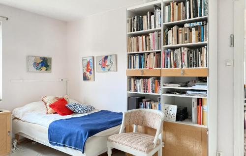 1 dormitorio con 1 cama y estantería con libros en Lovely Home In Slite With Wifi en Slite