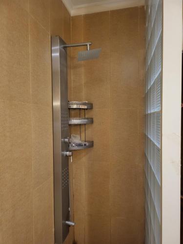 a shower with four shelves in a bathroom at Duplex by Aqua Maadi Degla Group 5 stars in Cairo
