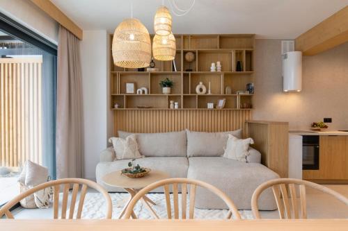 a living room with a couch and a table and chairs at Stylchyn Park - Czorsztyn Exclusive - by Upstairs in Kluszkowce