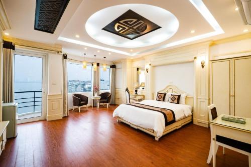 a bedroom with a bed and a large window at Wild Lotus Hotel Apartment 2 in Hanoi
