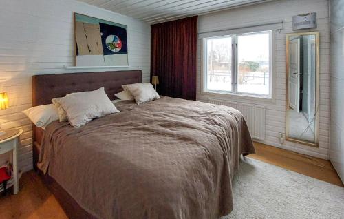 a bedroom with a large bed and a window at Beautiful Home In Hjrnarp With Jacuzzi in Hjärnarp