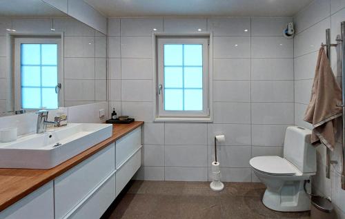 a white bathroom with a sink and a toilet at Gorgeous Home In Hjärnarp With Wifi in Hjärnarp
