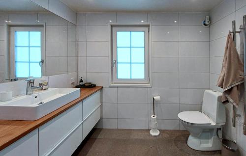 a white bathroom with a sink and a toilet at Beautiful Home In Hjrnarp With Jacuzzi in Hjärnarp