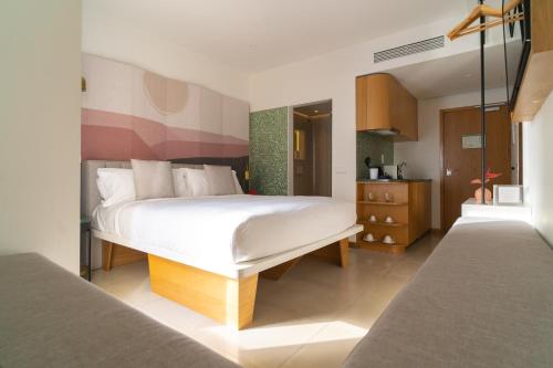 a bedroom with a large white bed in a room at Boutique Apartments Marsol Ibiza in Santa Eularia des Riu
