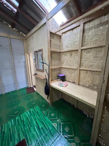 an empty room with a green floor and a window at Sofee Homestay(Bulone Island),Thailand in Ko Bulon Le