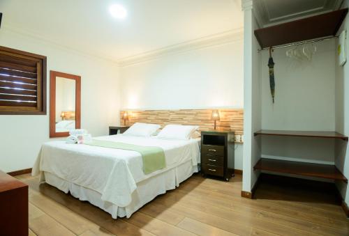 Postel nebo postele na pokoji v ubytování Hotel Vale das Nuvens