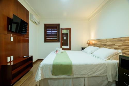 Postel nebo postele na pokoji v ubytování Hotel Vale das Nuvens