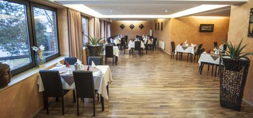a restaurant with tables and chairs in a room at Stargaze Home Hotel in Haan