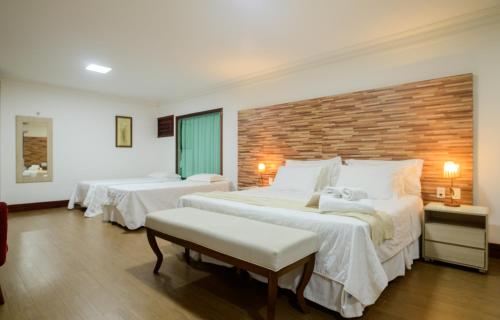 Postel nebo postele na pokoji v ubytování Hotel Vale das Nuvens