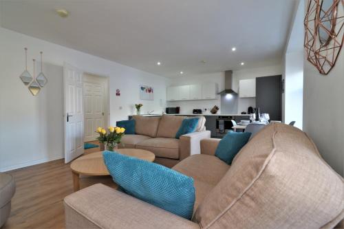 a living room with a couch and a table at Signature - No 5 Bonnet Apartments in Lanark