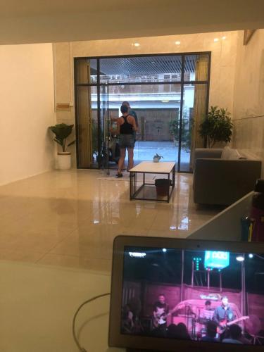 a person standing in a living room looking into a room at White House Guesthouse in Phnom Penh