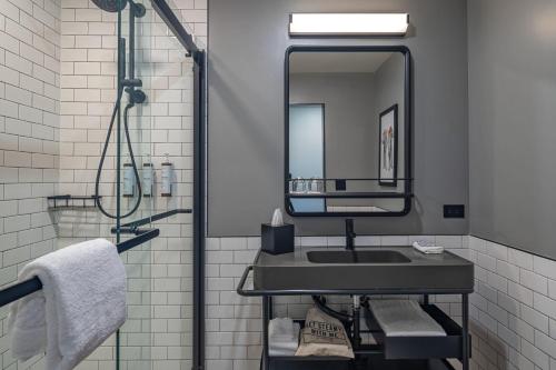 a bathroom with a sink and a mirror at Moxy Phoenix Downtown in Phoenix