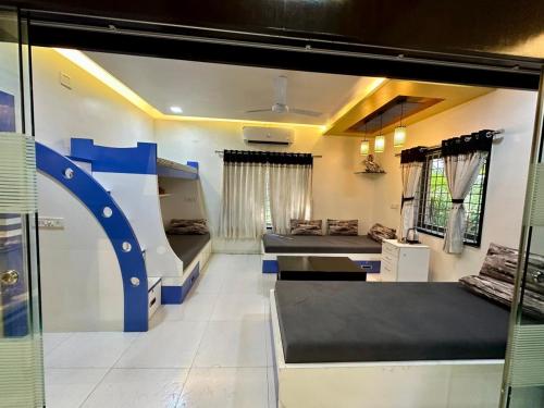 a room with two bunk beds and a couch at Farm stay in Ahmedabad in Ahmedabad