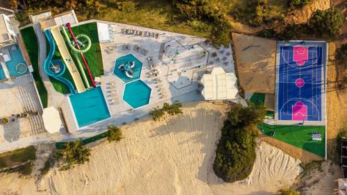 an overhead view of a resort with a swimming pool at Trypiti Resort Blue Dream Palace and Hive Water Park in Limenaria