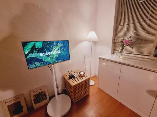 a living room with a flat screen tv on the wall at Yellow House - Duplex, Night view, White modern interior in Bucheon