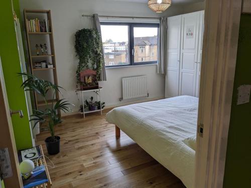 a bedroom with a bed and a window at Cheersome in London